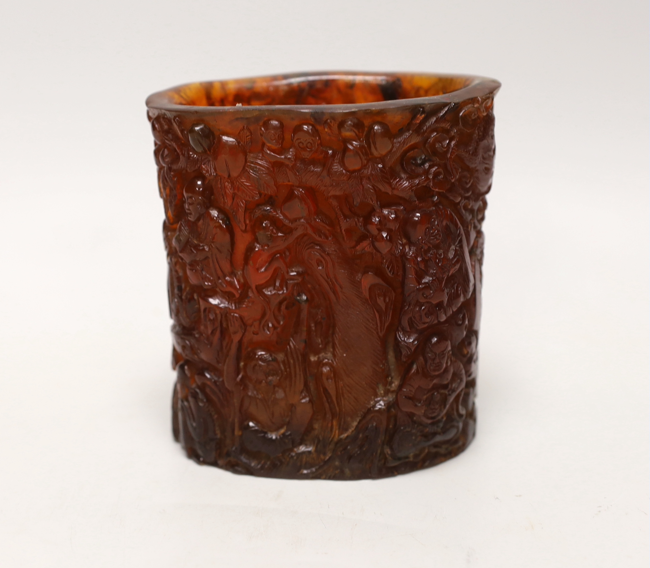 A Chinese amber coloured moulded plastic brush pot, 13.5cm